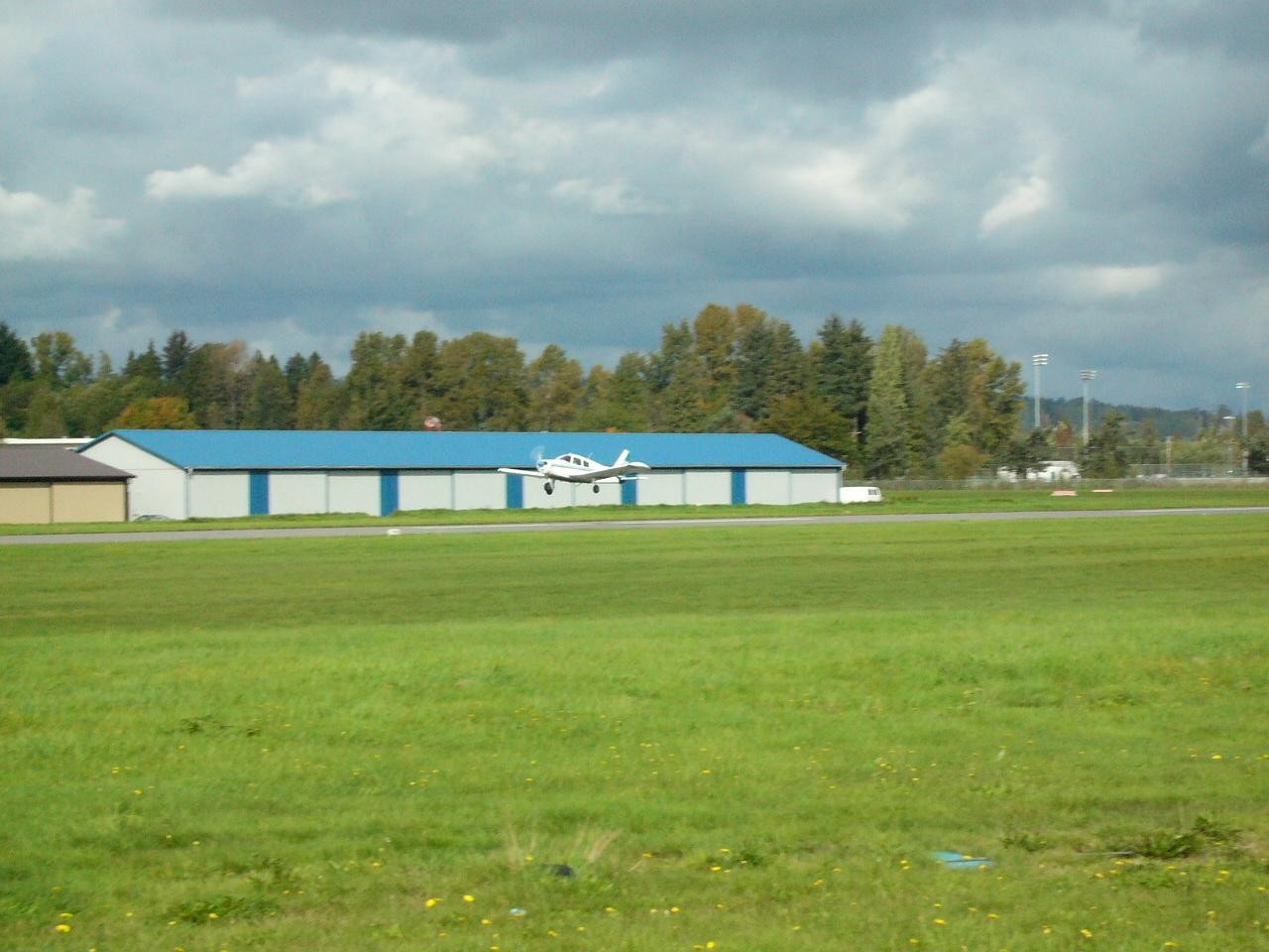 Piper Cherokee GNIC during flare for landing on Runway 19 at Langley Airport.  Langley Flying School.