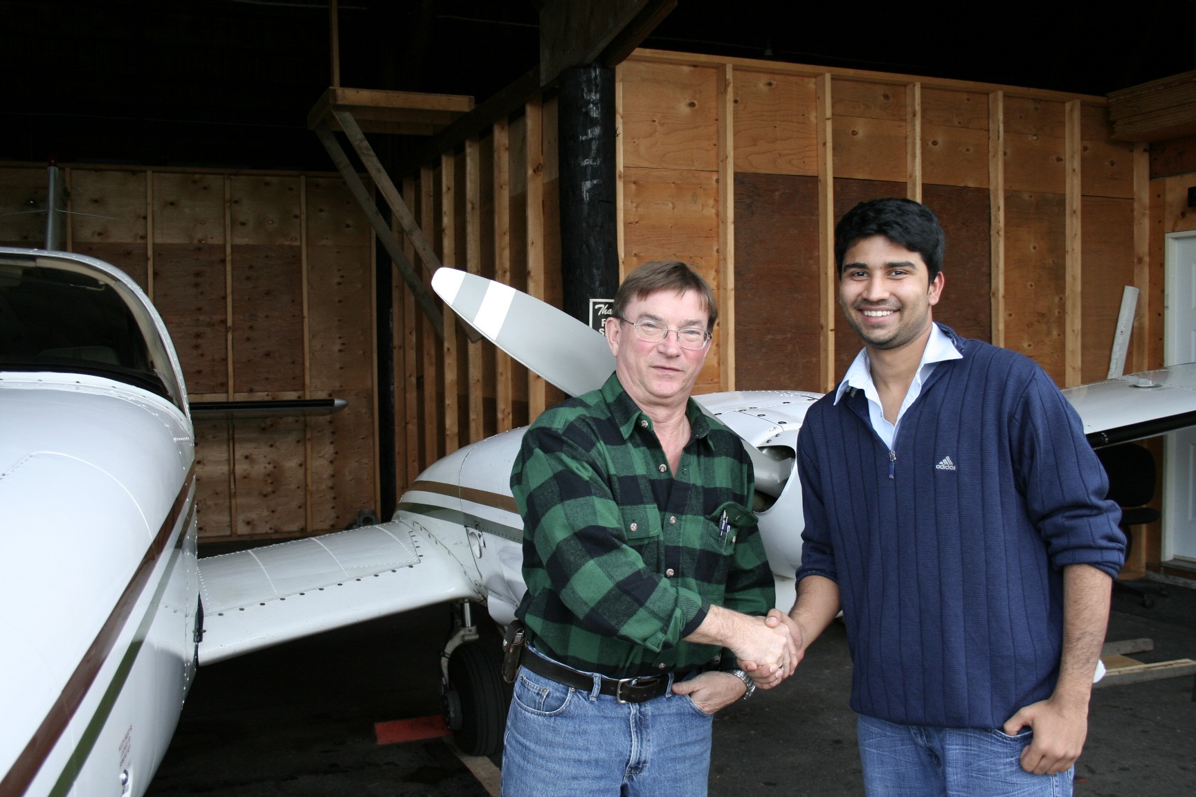 Abhinav Sonak receives congratulations form Pialot Examiner John Laing.  Langley Flying School.