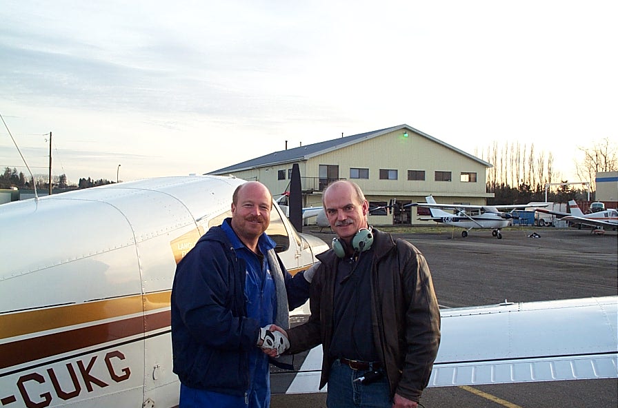 Alan March receives contratulations form Chief Flying Instructor David Parry after the completion of Alan's First Solo Flight on December 8, 2007. Langley Flying School.