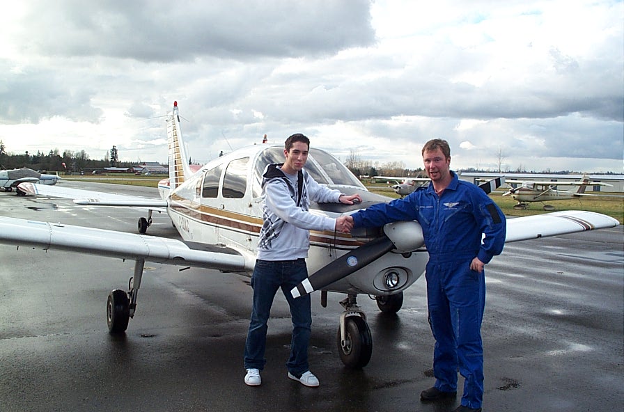 Alex Birch with Flight Instructor Darren Ferguson after completing his First Solo Flight on December 5, 2007. Langley Flying School.