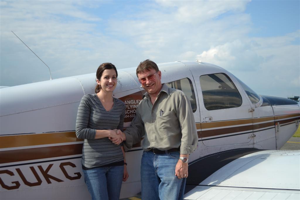 Allison Heathcote receives contgratulations from Pilot Examiner John Laing after the successful completion of Allison's Private Pilot Flight Test on June 5, 2011. Langley Flying School