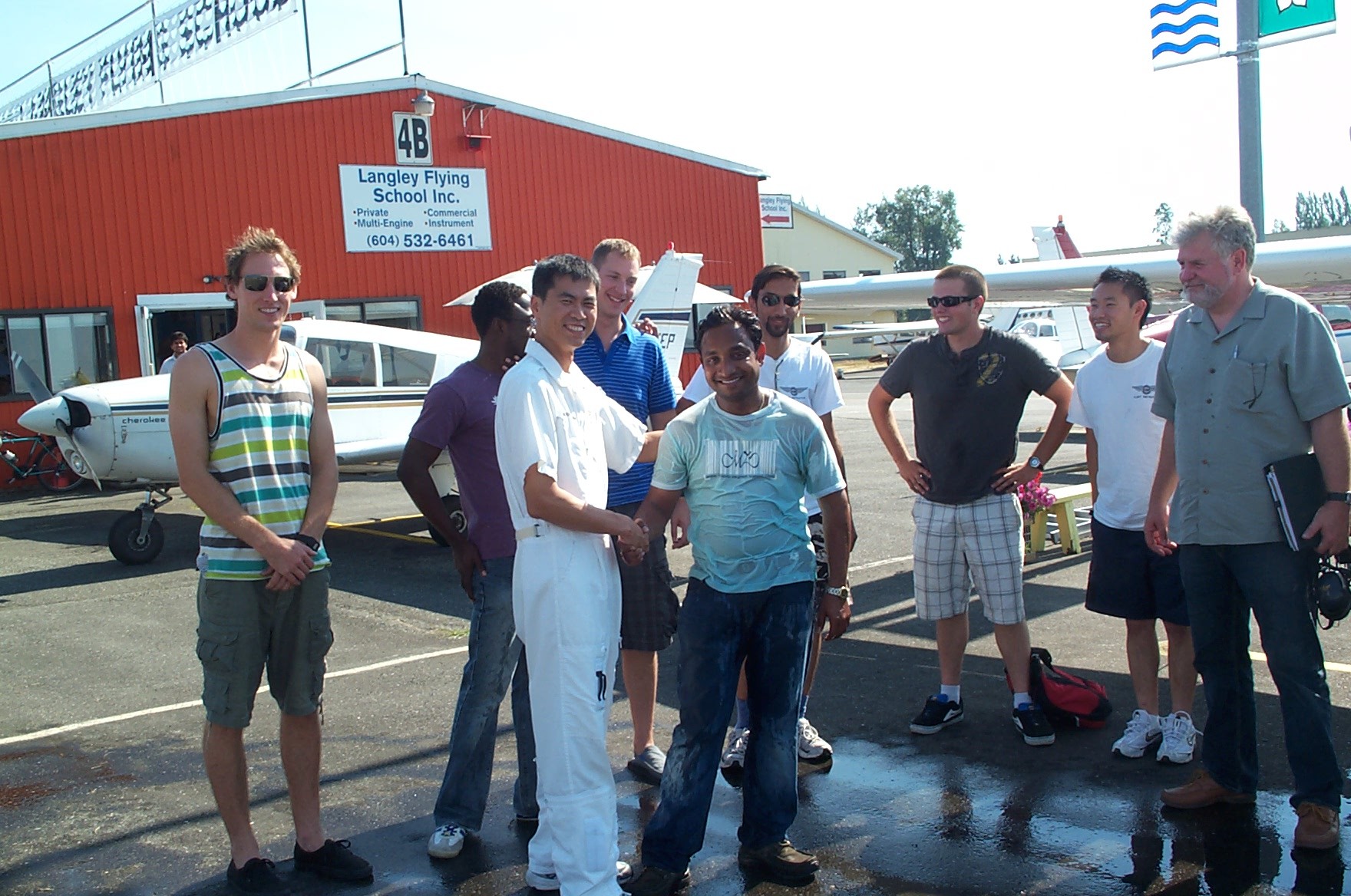 Aniket Chavan receives congrats from his Flight Instructor, Hoowan Nam, after the successful completion of Anikets's Commercial Pilot Flight Test.  Langley Flying School.