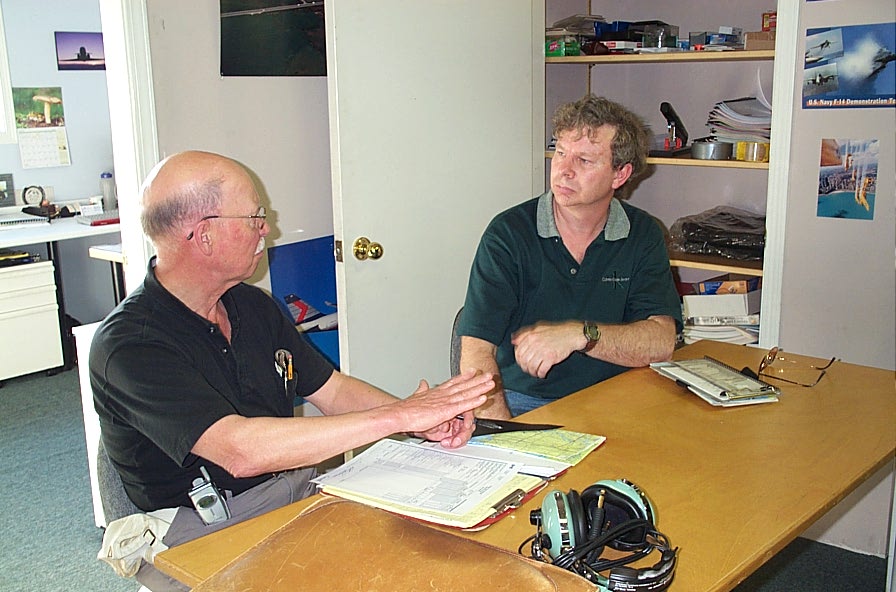 Brian Downing with Donn Richardson during the debriefing following Brian's successful Private Pilot Flight Test.  Langley Flying School.