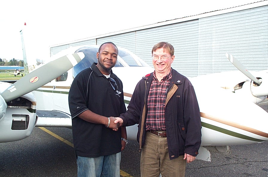 Christopher Russell receives contratulations form Pilot Examiner Captain John Laing.  Langley Flying School.