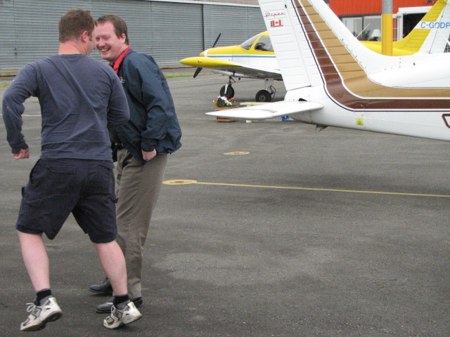 Flight Instructor Darren Fergson and Transport Canada Inspector Peter Cox--Darren is fleeing from a potential soaking.  Langley Flying School