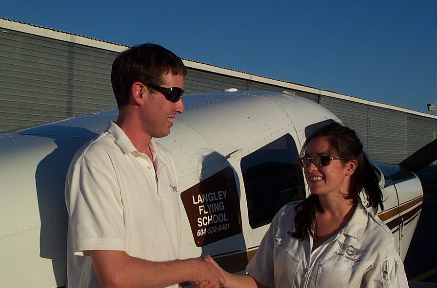 Dean Bicknell is congratulated by Flight Instructor Naomi Jones after the completion of his First Solo Flight. Langley Flying School.