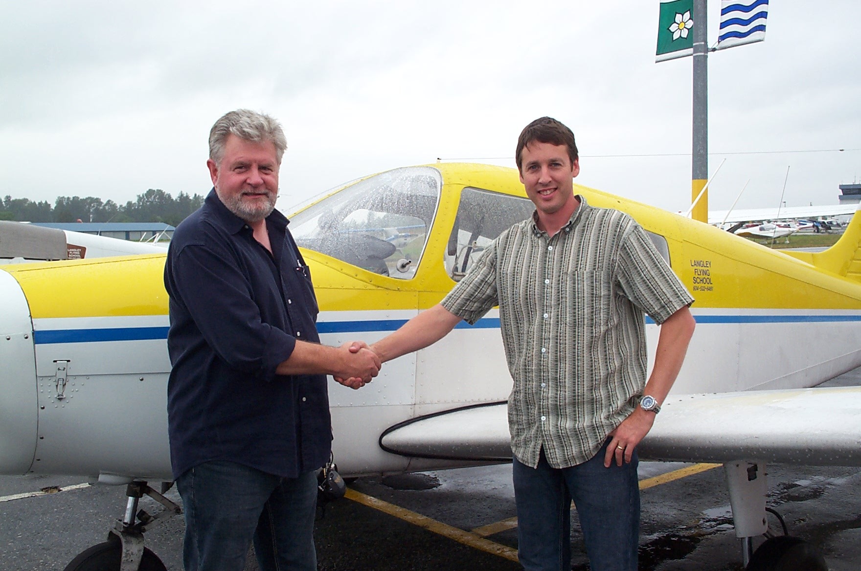 Dean Bicknell receives congratulations from Pilot Examiner Paul Harris after the successful completion of Dean Private Pilot Flight Test. Langley Flying School.