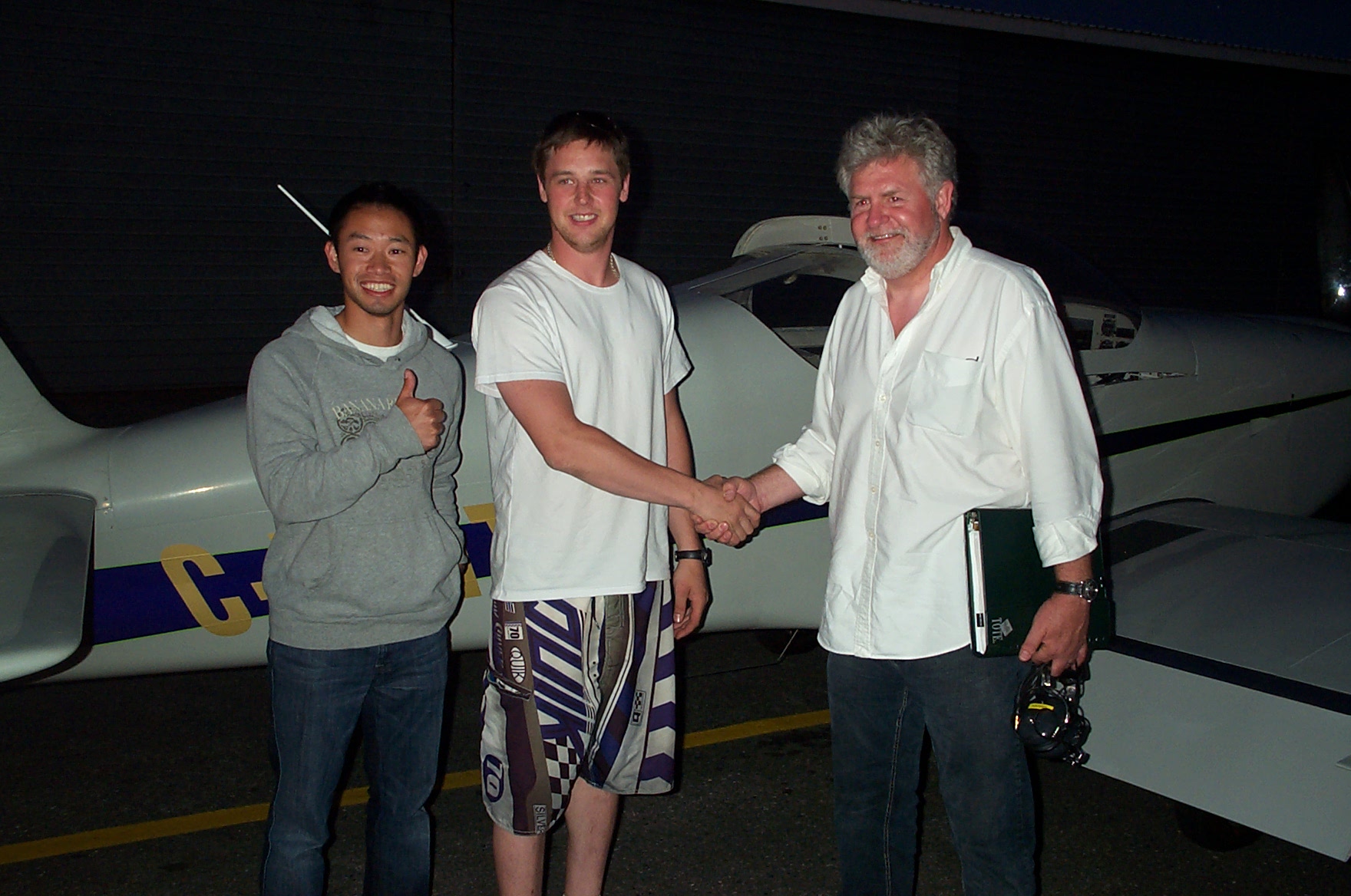 Derrek Sutter receives contratulations from his Flight Instructor Nam Vu and Pilot Examiner Paul Harris, following the successful completion of Derrek's Private Pilot Flight Test on July 6, 2010. Congrats also to Derrek's previous Flight Instructors, Rod Giesbrecht and Naomi Jones.  Langley Flying School.