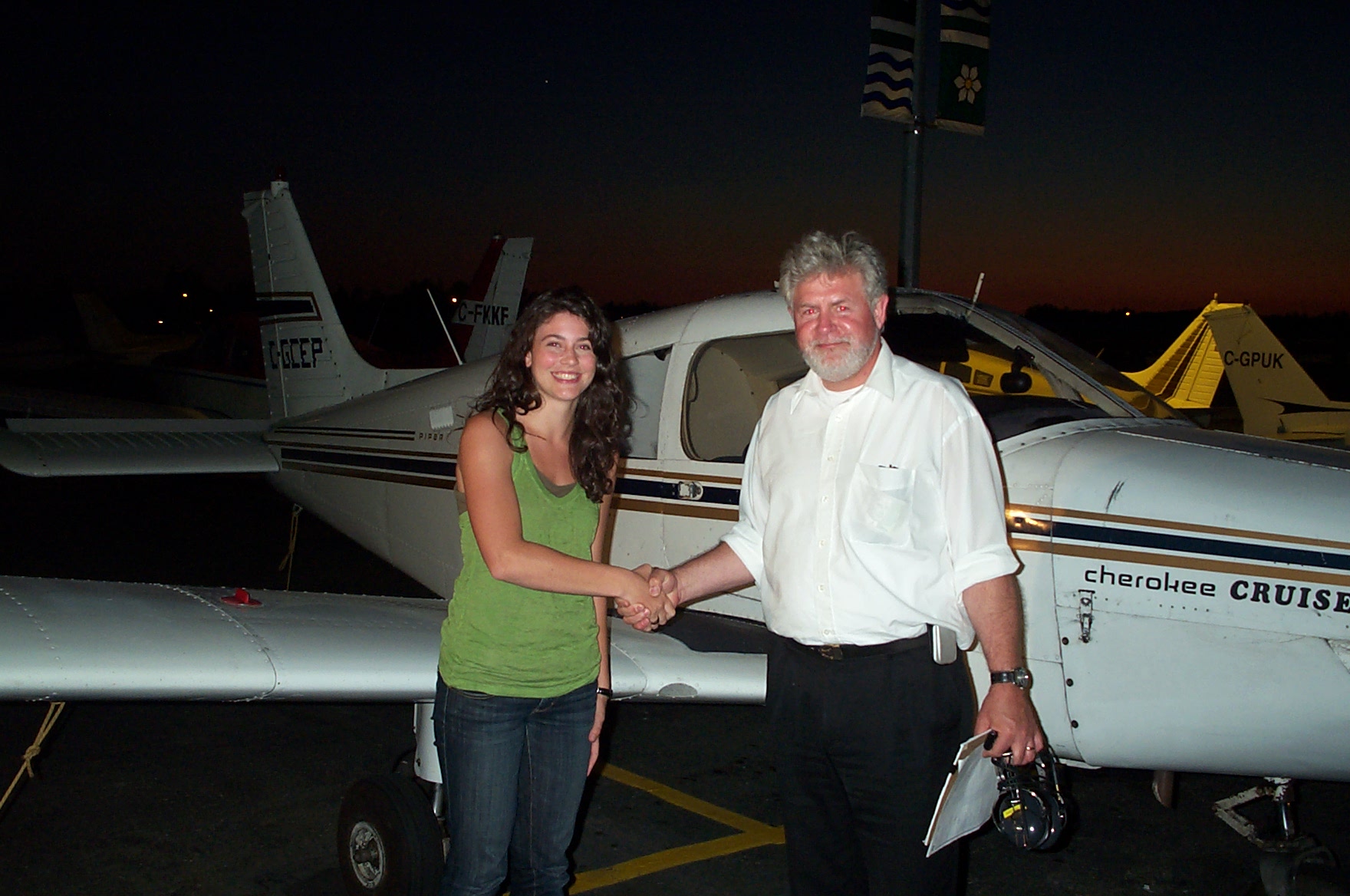 Karlee Janzen receives contratulations from Pilot Examiner Paul Harris after the successful completion of Karlee's Private Pilot Flight Test on July 16, 2010. Congrats also to Karlee's Flight Instructor, Mayank Mittal. Langley Flying School.
