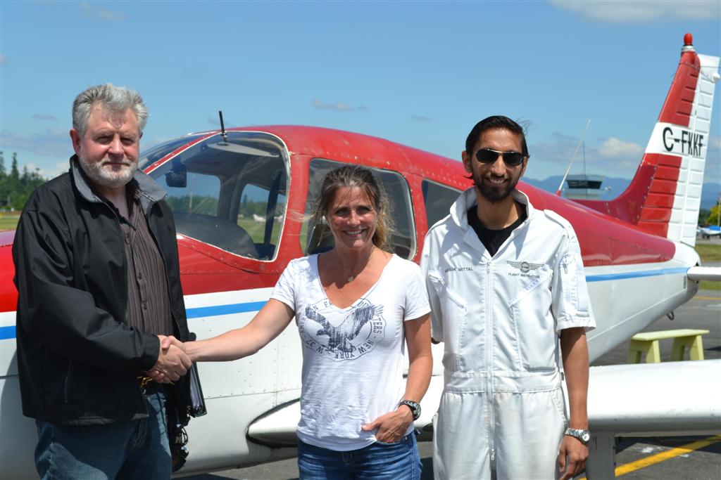 Katie de Sousa receives contgratulations from Pilot Examiner Paul Harris, and her Flight Instructor, Mayank Mittal, after the successful completion of Katie's Private Pilot Flight Test on June 26, 2011. Langley Flying School.