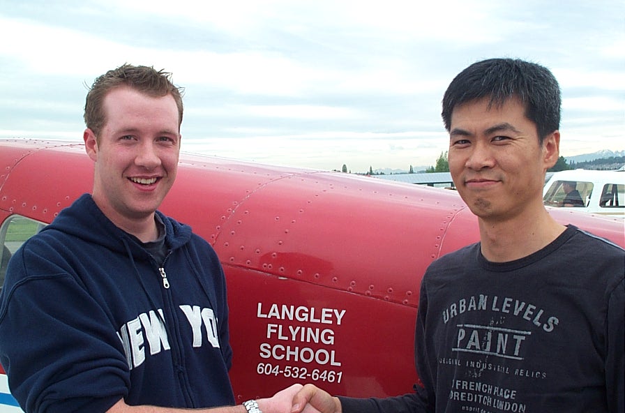 Kirk Palmer receives congratulations from Flight Instructor Hoowan Nam after the successful completion of Kirk's Private Pilot Flight Test on . May 23, 2008. Langley Flying School.