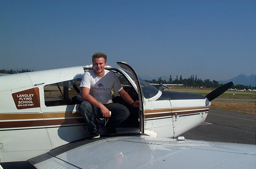 Lucas Turek on the wing of Cherokee GUKG after completing his First Solo Flight on August 6, 2008.  Langley Flying School. 