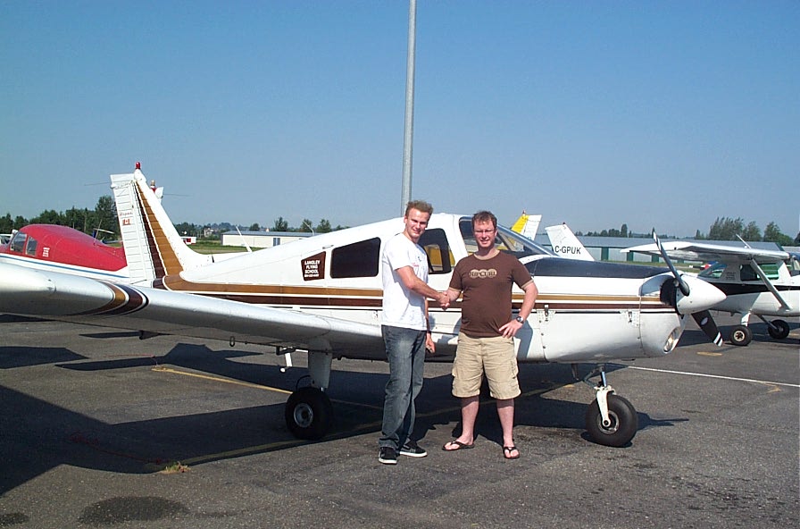 Lucas Turek receives congrats form Flight Instructor Darren Ferguson after the completion of Lucas' First Solo Flight on August 6, 2008.  Langley Flying School.