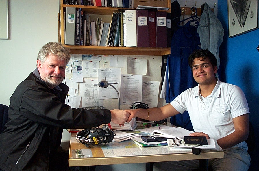 Manoj Shelke with Pilot Examiner Paul Harris after the successful completion of Manoj's Private Pilot Flight Test on May 4, 2009.  Langley Flying School.