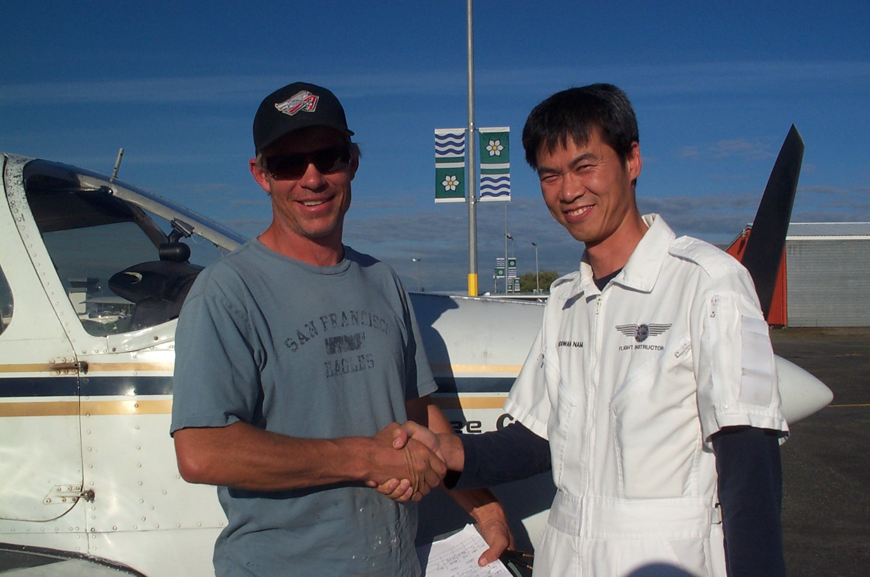 Darryl (Mark) Reid is congratulated by Flight Instructor Hoowan Nam after the completion of Mark's Second/First Solo Flight in Cherokee GCEP on September 22, 2010. Langley Flying School.