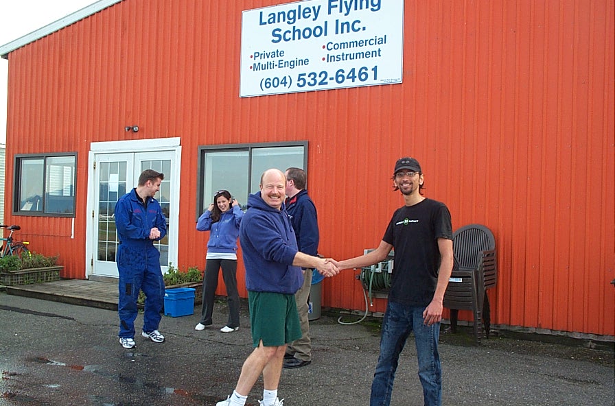 Mayank . . although wet . . is congratulated by Dave Parry. Langley Flying School.
