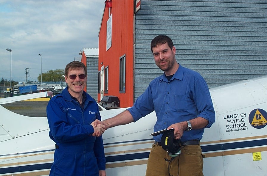 Milan Veverka receives contratulations from Flight Instructor Peter Waddington after completing his First Solo Flight on May 8, 2008. Langley Flying School.