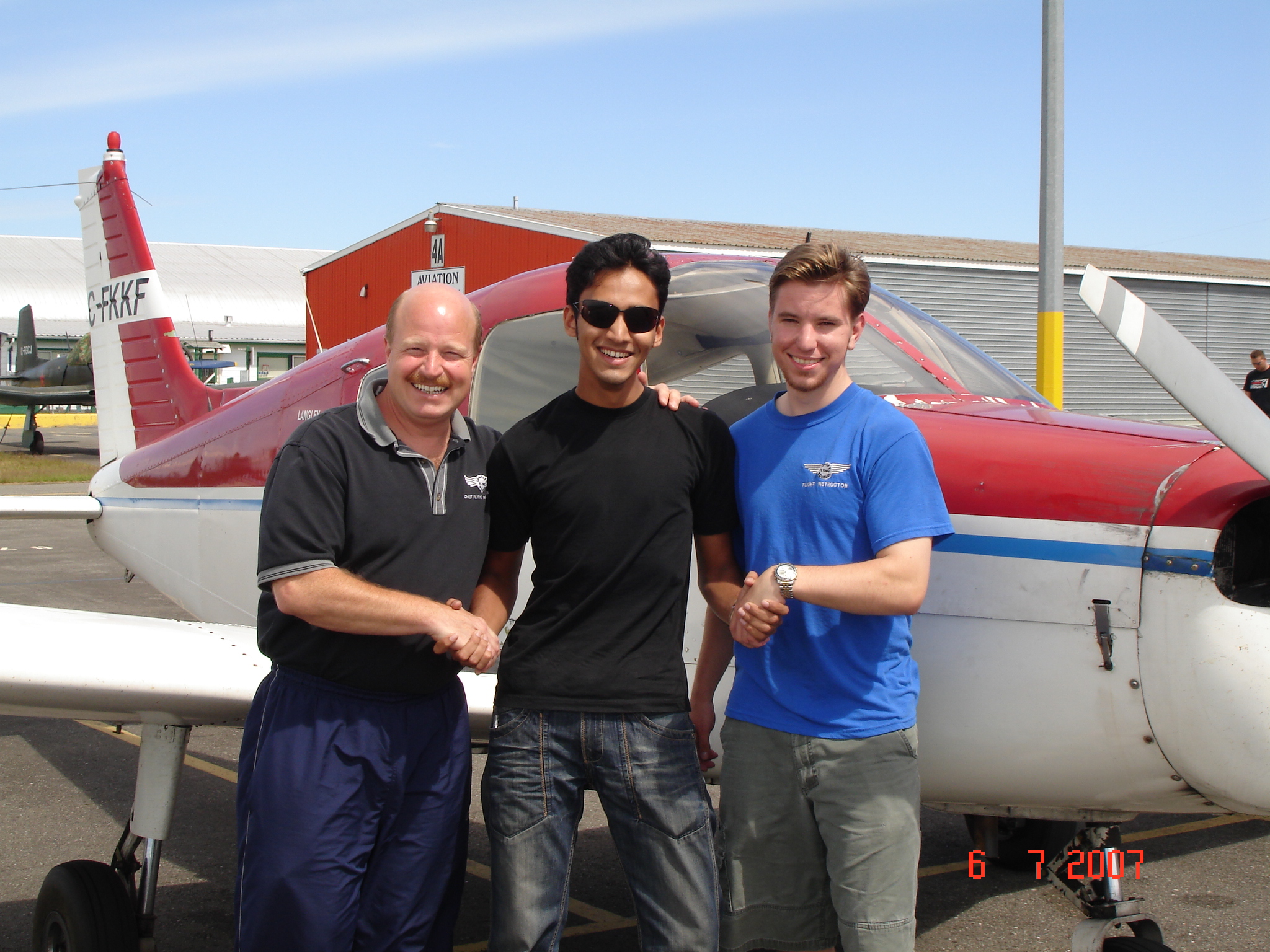Naif Malvankar with David Parry and Philip Craig after the successful completion of his Private Pilot Flight Test, Langley Flying School
