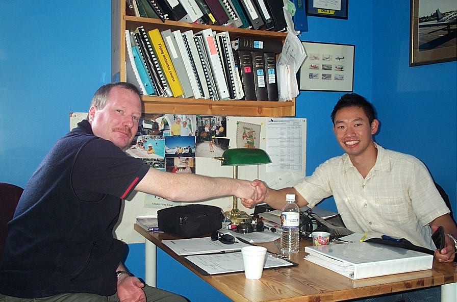 Nam Vu receives congratulations from Pilot Examiner Peter Cox after the successful completion of Nam's ride for his Class IV Flight Instructor Rating.