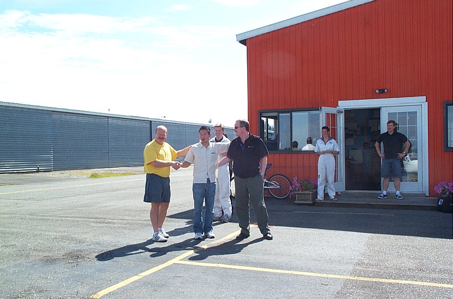 Nam Vu with his Flight Instructor, David Parry, and Transport Canada Inspector Peter Cox.  Phil Craig and Aniket Chavan do the bucket deed, with Flight Instructor Naomi Jones and Peter Waddington look on.  Langley Flying School.