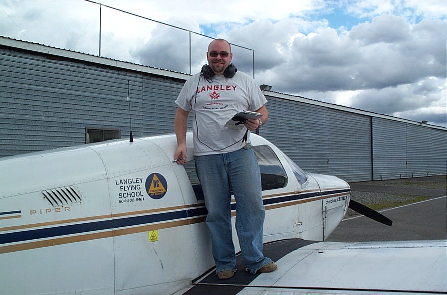 Nathan Twist on the wing of Cherokee GCEP after the completion of his First Solo flight on March 22, 2010.  Langley Flying School.