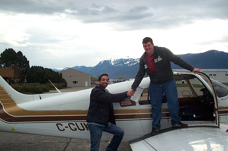 Student Pilot Nocholas Mufford receives congratulations from his Flight Instructor, Mayank Mittal, after the completion of Nicholas' First Solo Flight on March 2, 2010. The event occurred at Chilliwack Airport owing to the airspace restrictions with the Vancouver Winter Olympics. Langley Flying School.