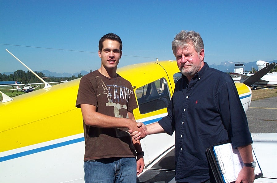 Noel Amyot with Pilot Examiner Paul Harris after the successful completion of Noel's Private Pilot Flight Test on September 14, 2008.  Langley Flying School.