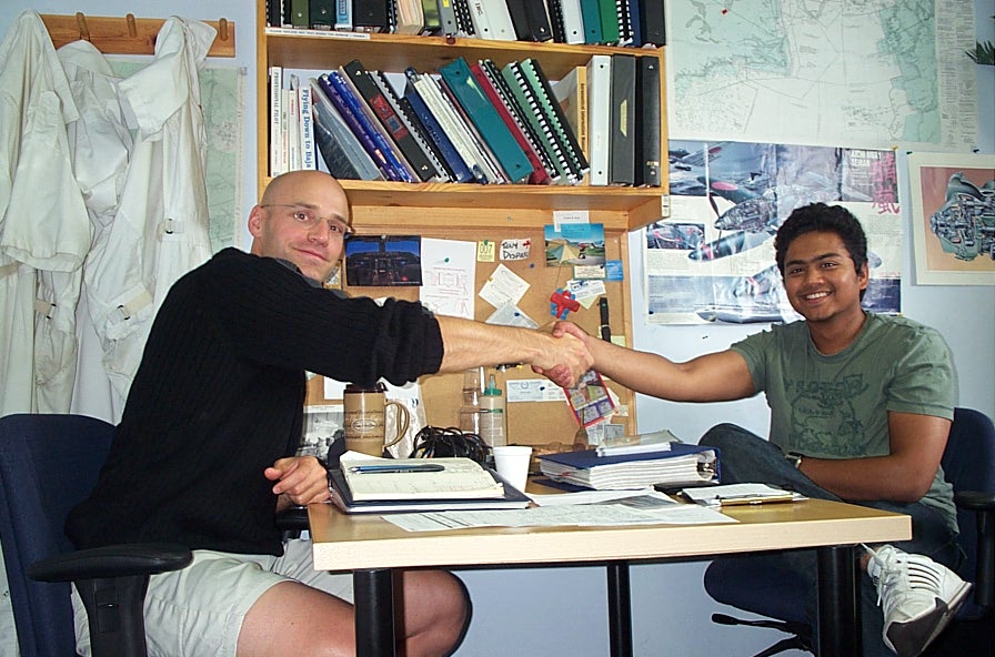 Panks Salve is congratulated by Pilot Examiner Todd Pezer after the completion of flight test. La Langley Flying Sch ool