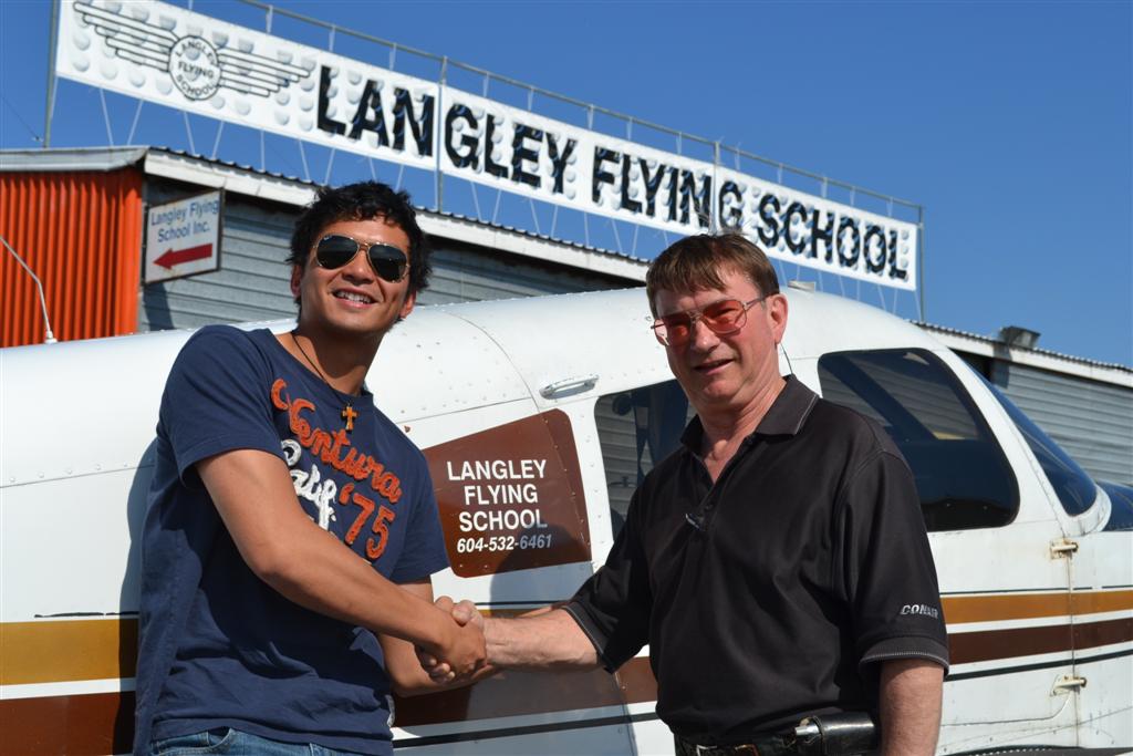 Paolo Parjan receives contgratulations from Pilot Examiner John Laing after the successful completion of Paolo's Private Pilot Flight Test on July 2, 2011.