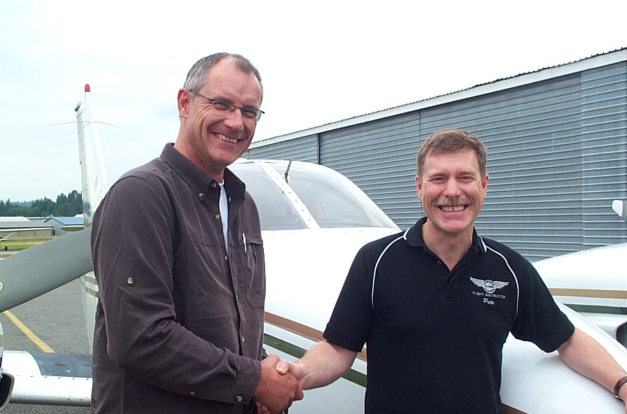 Peter Waddington receives congratulations from Pilot Examiner Matt Edwards after the succesful completion of Peter's flight test for the Group 1 (Multi-engine) Instrument Rating on June 26, 2008. Langley Flying School.
