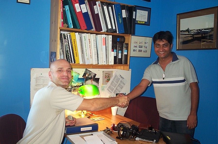 Raman Srivastava is congratulated by Pilot Examiner Todd Pezer after the successful completion of Raman's Group 1 (Multi-engine) Instrument Rating on September 14, 2008.  Langley Flying School
