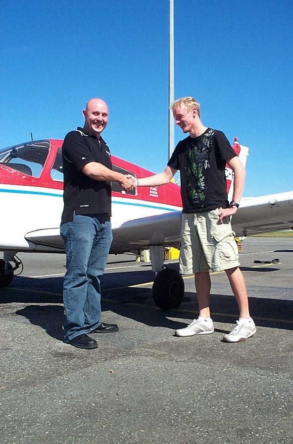 Ryan Kavanagh receives contratulations from Flight Instructor Rod Giesbrecht after the successful completion of Ryan's Private Pilot Flight Test on September 7, 2008. Langley Flying School.