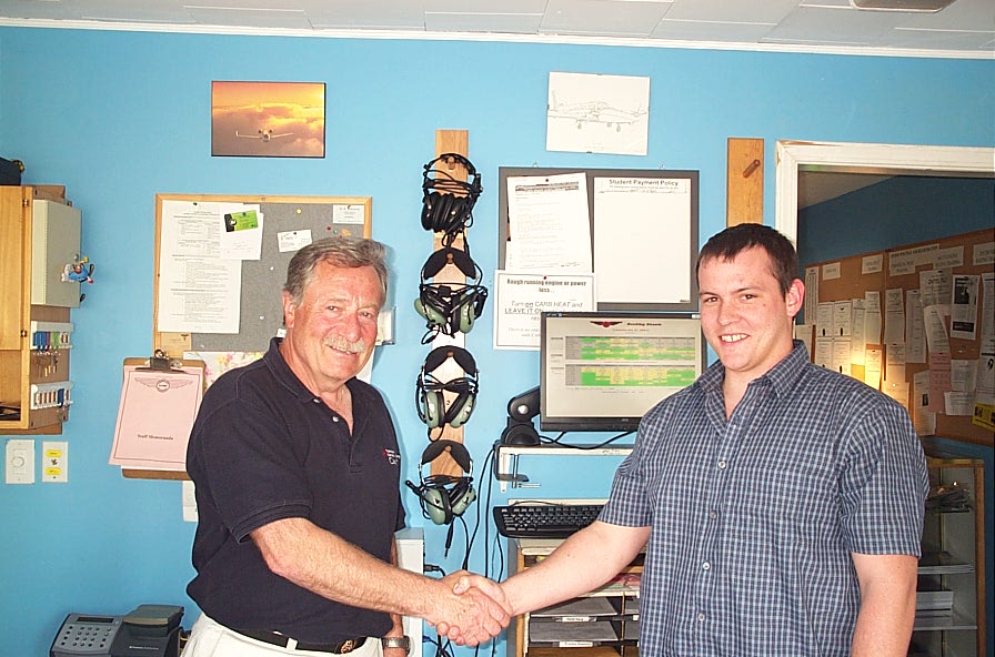 Scott Little receives congratulations from Pilot Examiner and Transport Canada Inspector John Mrazek after the successful completion of his Group 1 (Multi-engine) Instrument Rating Flight Test on May 30, 2008.  Langley Flying School.