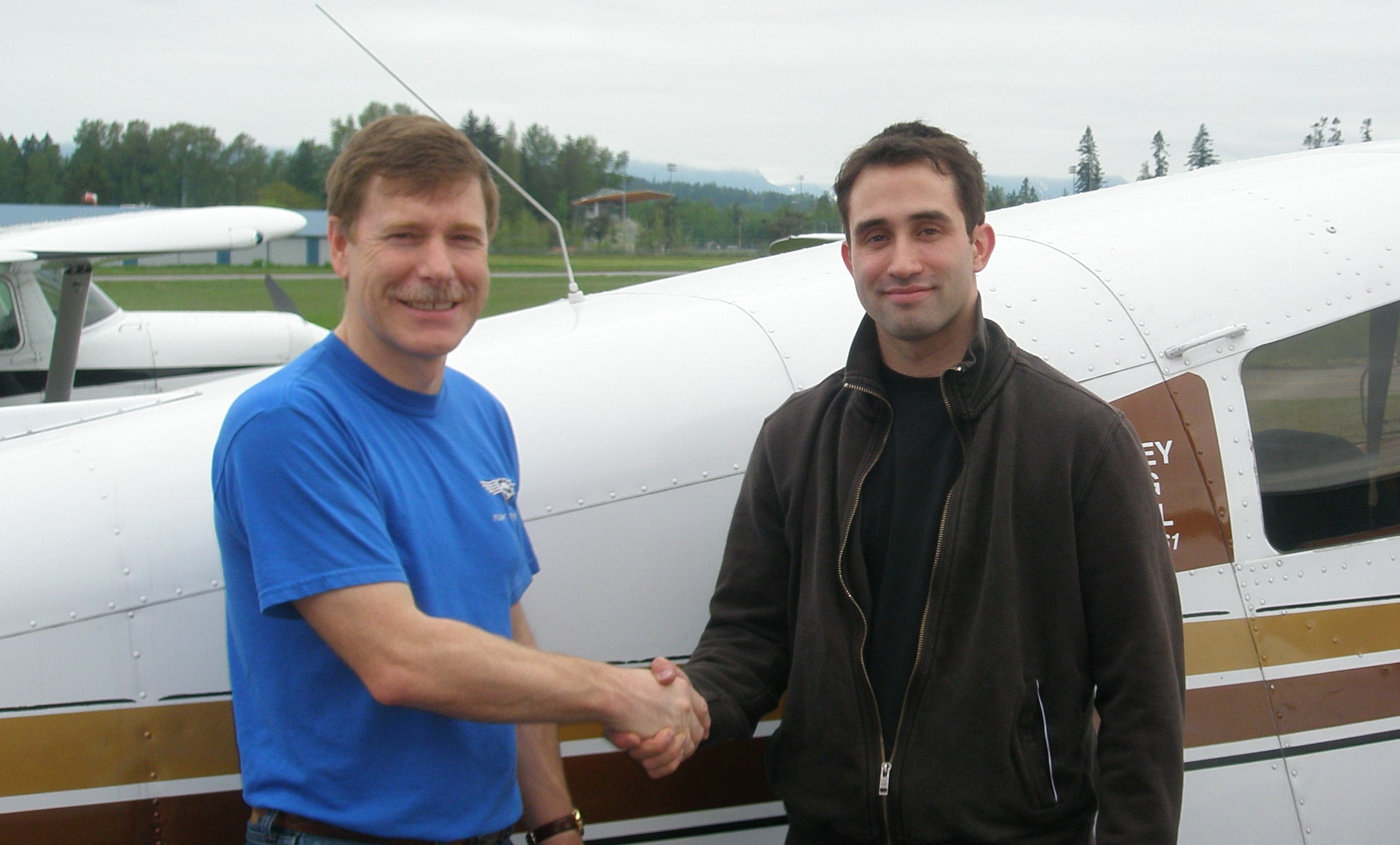 Shadrin Storness-Bliss receives contratulations from Flight Instructor Peter Waddington after the successful completion of Shad's Commercial Pilot Flight Test on May 15, 2008. Langley Flying School.