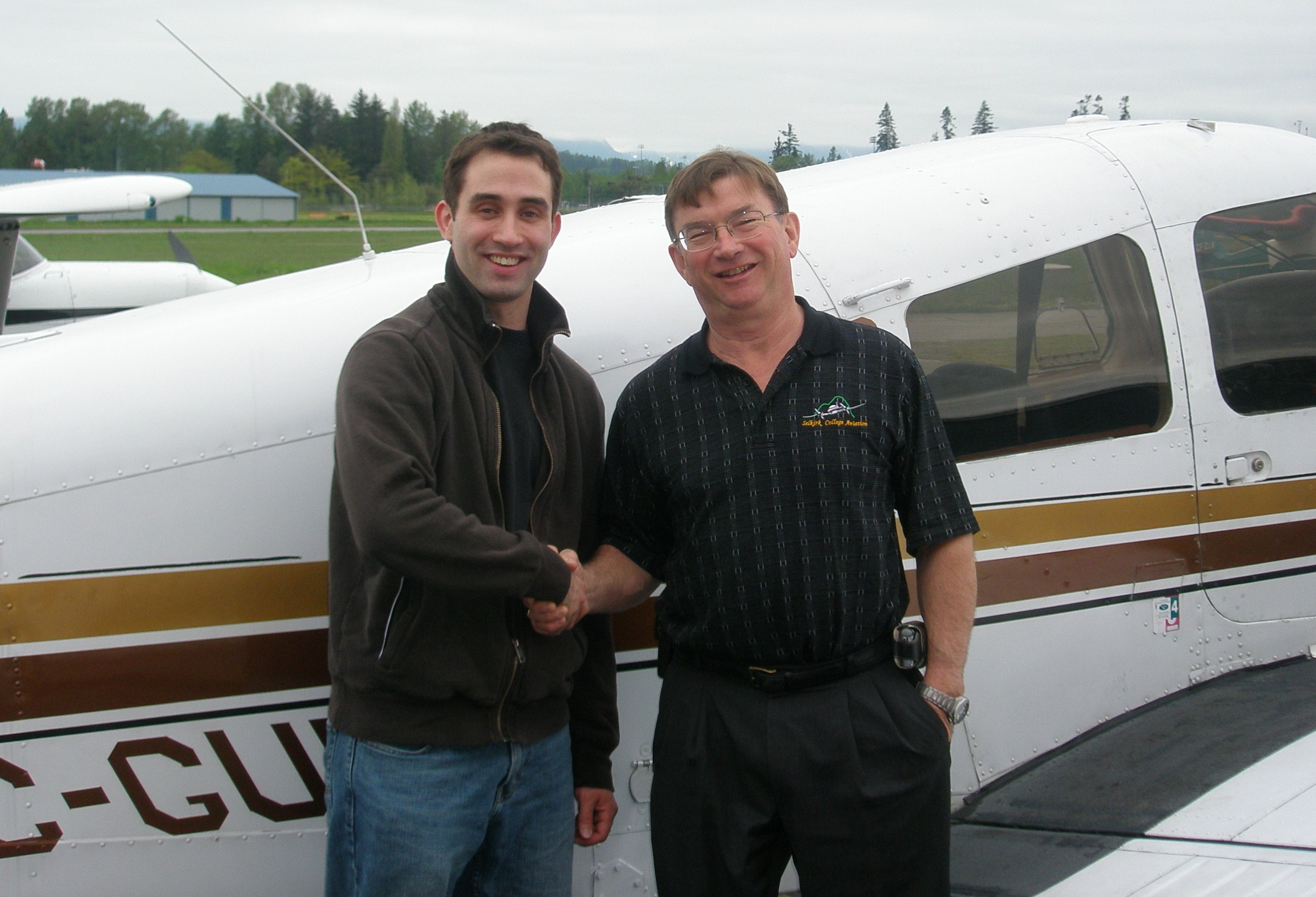 Shadrin Storness-Bliss with Pilot Examiner John Laing after the successful completion of Shad's Commercial Pilot Flight Test on May 15, 2008. Langley Flying School