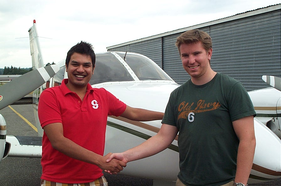 Commercial Pilot Vikas Choudhary receives congratulations from his Flight Instructor, Phil Craig, after the successful completion of his Multi-engine Class Rating on August 21, 2009 with Pilot Examiner Todd Pezer. Langley Flying School.