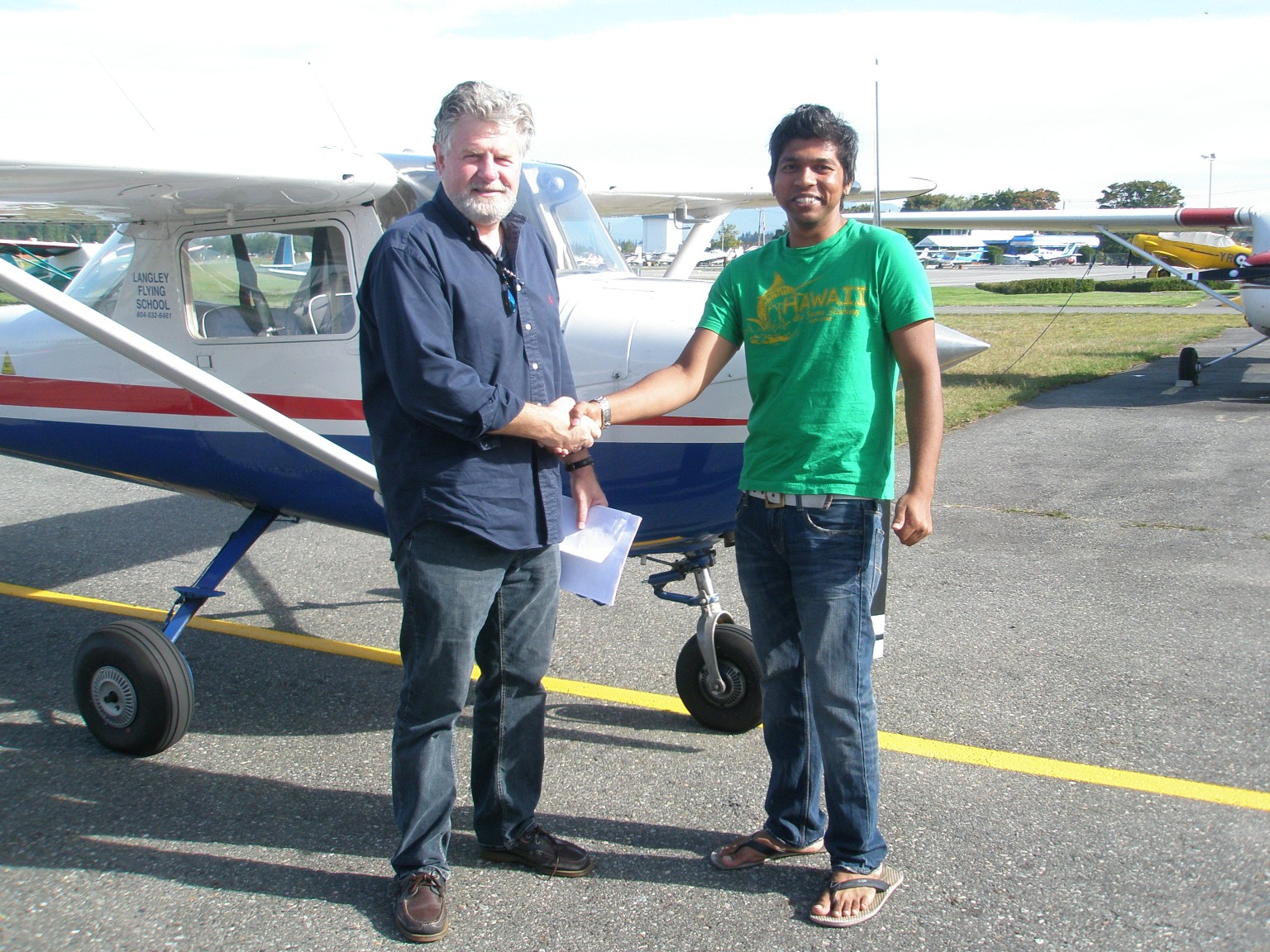 Vinit Shinde with Pilot Examiner Paul Harris after the successful completion of Vinit's Private Pilot Flight test on September 21, 2009.  Langley Flying School.