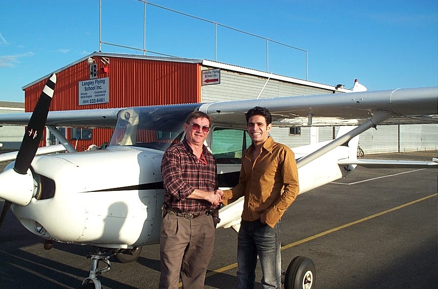 Ali Rumani with Pilot Examiner John Laing after the successful completion of Ali's Commercial Pilot Flight Test.  Langley Flying School.