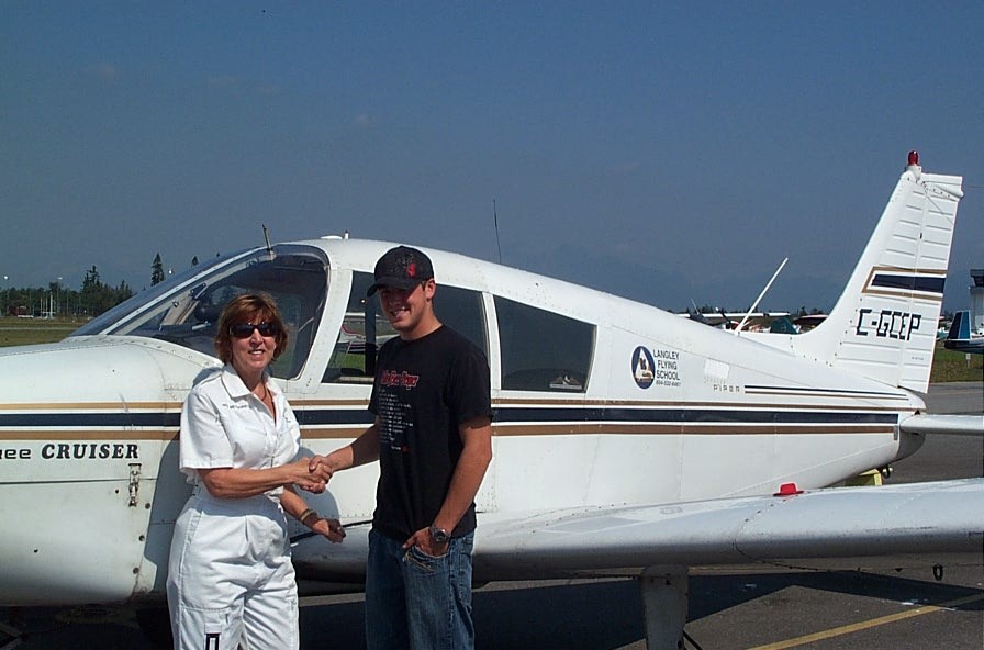 Pilot Brooklyn Anderson receives congrats from his Flight Instructor Rita Methorst.  August 31, 2009.  Langley Flying School.