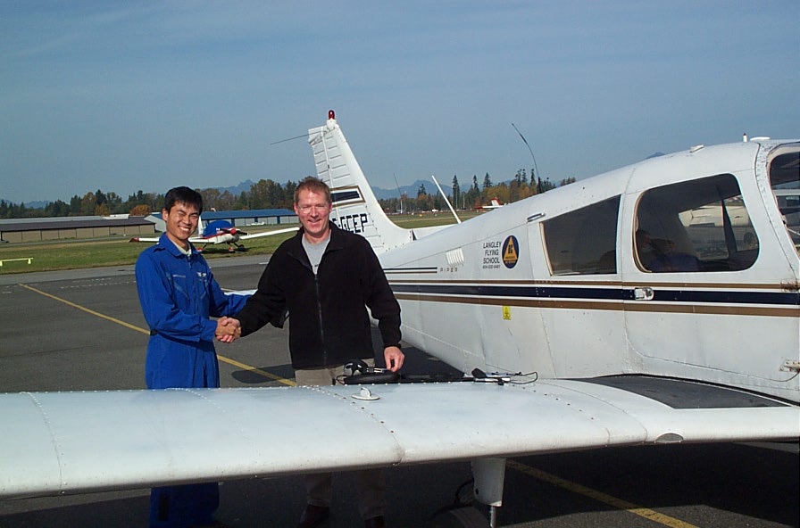 Darren Grant receives congratulations from Flight Instructor Hoowan Nam after the completion of Darren's First Solo Flight on October 26, 2008.