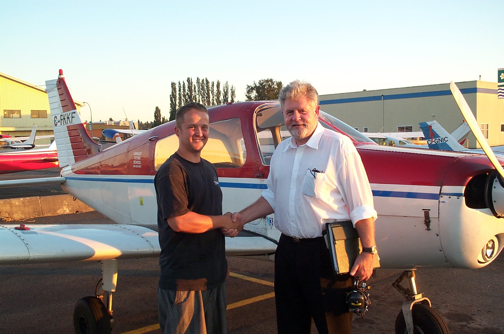 Jason Nel with Pilot Examiner Paul Harris after the successful completion of Jason's Private Pilot Flight Test.  Langley Flying School.