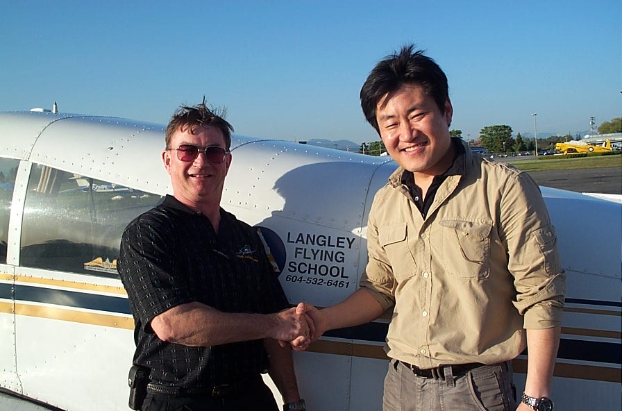 Jeff Kim receives contratulations from Pilot Examiner John Laing after the successful completion of Jeff's Commercial Pilot Flight Test on May 15, 2008.  Langley Flying School.