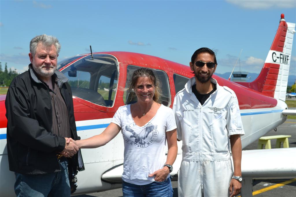 Katie de Sousa receives contgratulations from Pilot Examiner Paul Harris, and her Flight Instructor, Mayank Mittal, after the successful completion of Katie's Private Pilot Flight Test on June 26, 2011.  Langley Flying School.
