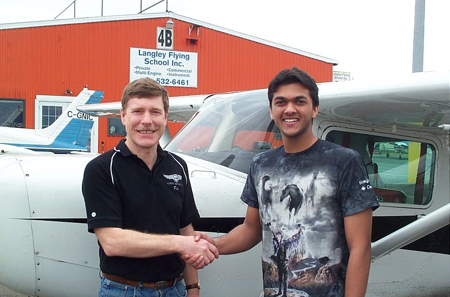 Mohit Goyle receives contratulations from Flight Instructor Peter Waddington after the successful completion of Mohit's Commercial Pilot Flight Test.  Langley Flying School.