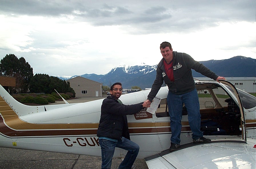 Student Pilot Nocholas Mufford receives congratulations from his Flight Instructor, Mayank Mittal, after the completion of Nicholas' First Solo Flight on March 2, 2010.  The event occurred at Chilliwack Airport owing to the airspace restrictions with the Vancouver Winter Olympics.  Langley Flying School.