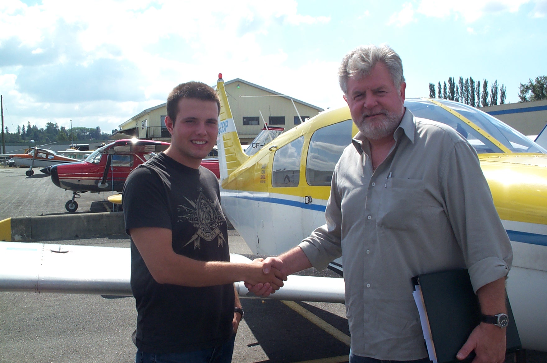 Ryan Fielding receives congrats from his Pilot Examiner Paul Harris after the successful completion of Ryan's Private Pilot Flight Test on August 30, 2010. Congratulations also to Ryan's Flight Instructor, Rita Methorst.  Langley Flying School.