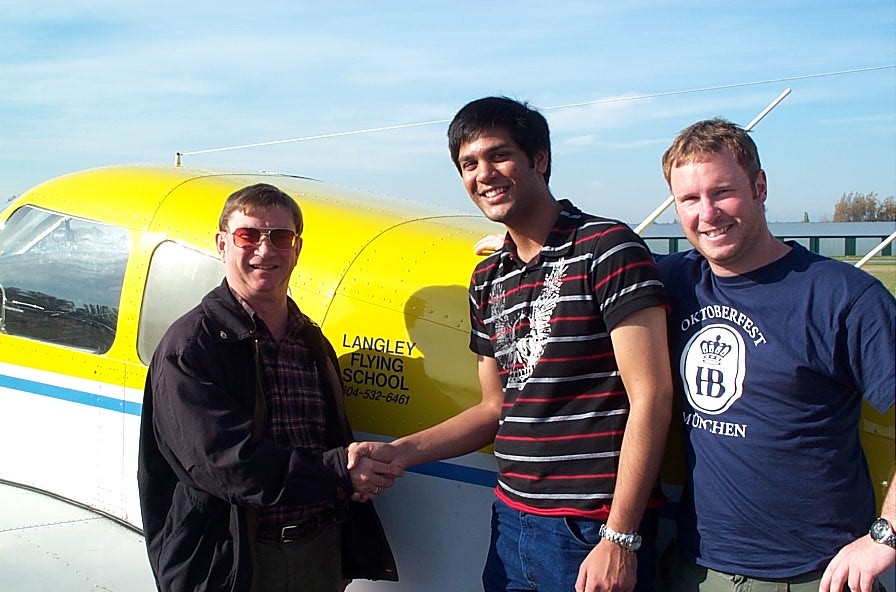 Suraj Canakapalli receives congratulations from Pilot Examiner John Laing and Flight Instructor Darren Ferguson.  Langley Flying School.