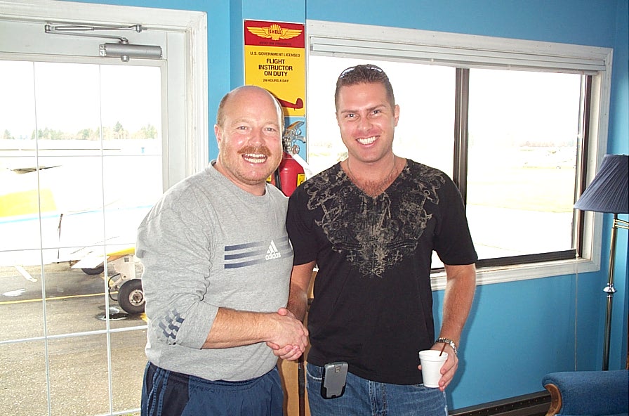 Chief Flying Instructor Dave Parry with Langley Flying Commercial Pilot Graduate Micheal Holmes.  Mike became the Chief Pilot for a regional US airline at the age of 25 years, and is now a First Officer on the Airbus 340 with Cathay Pacific. December, 2008.  Langley Flying School.