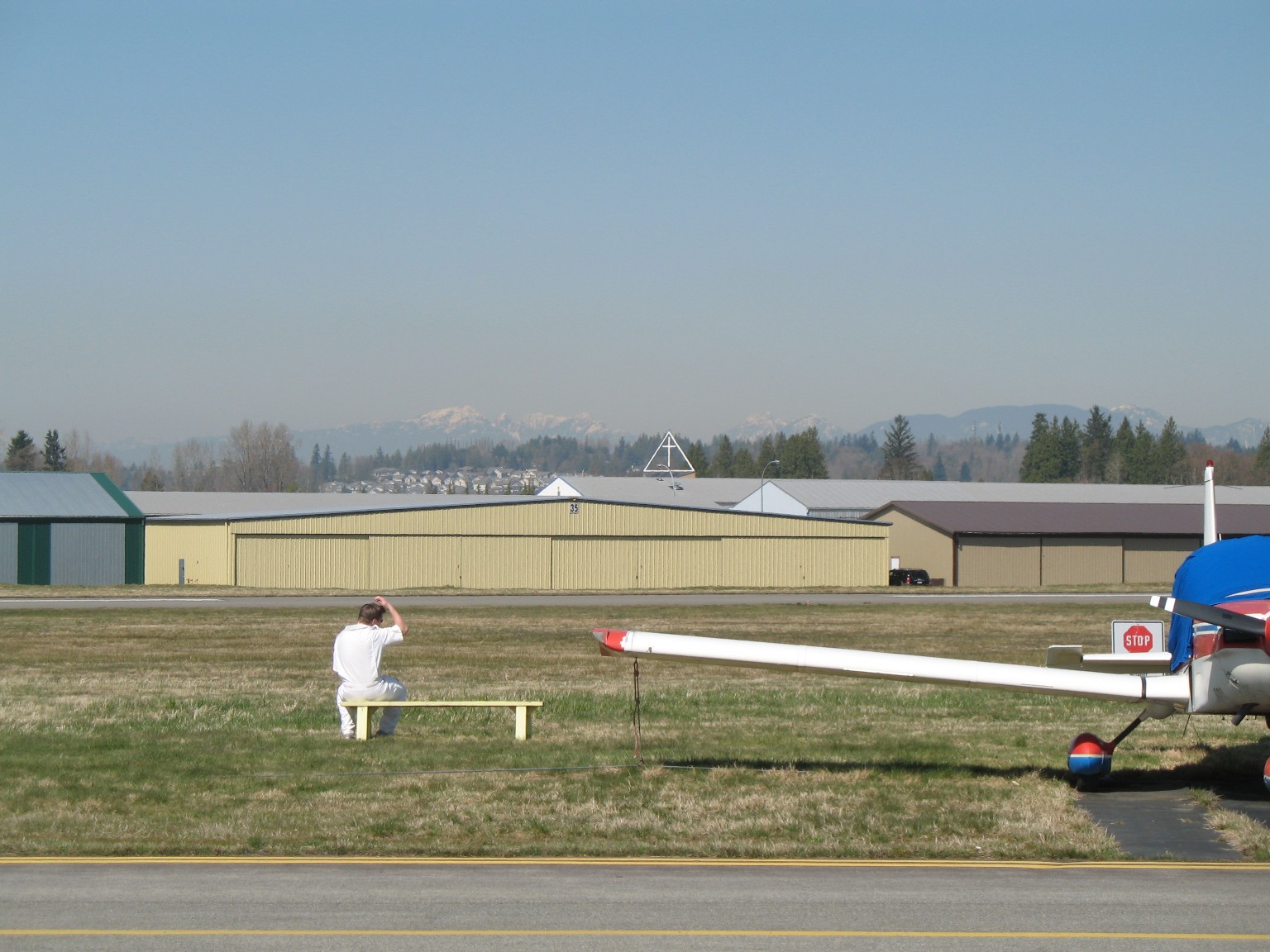 Flight Instructor Philip Craig watching his student, David Marshall, complete his First Solo Landing.  Langley Flying School.