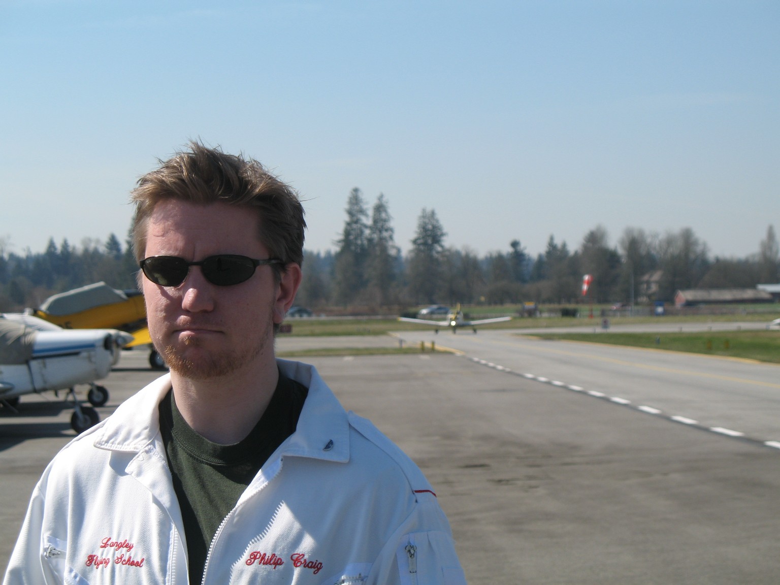 Flight Instructor Philip Craig with his student, David Marshall, taxiing in after his First Solo landing (background).  Langley Flying School.